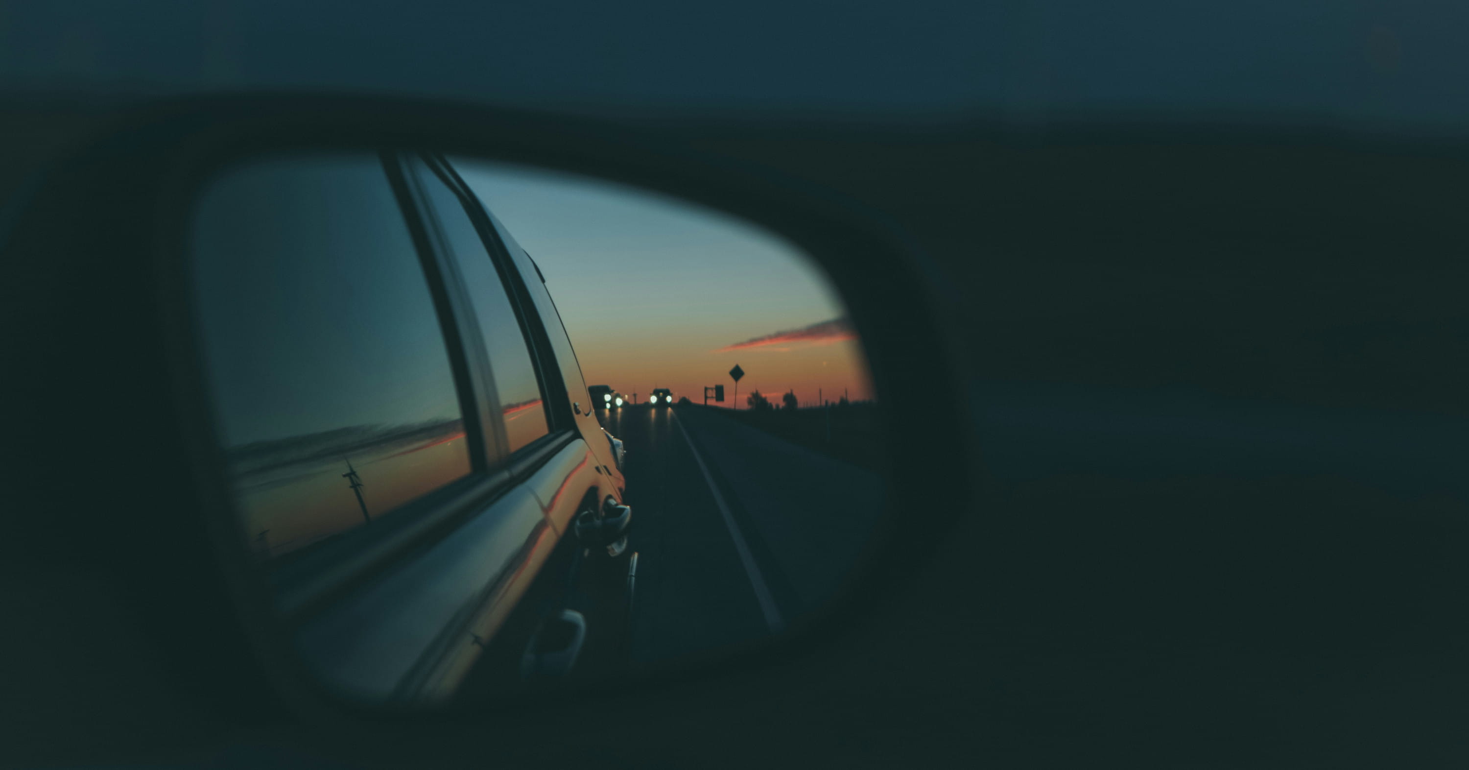 shallow focus photo of car side mirror