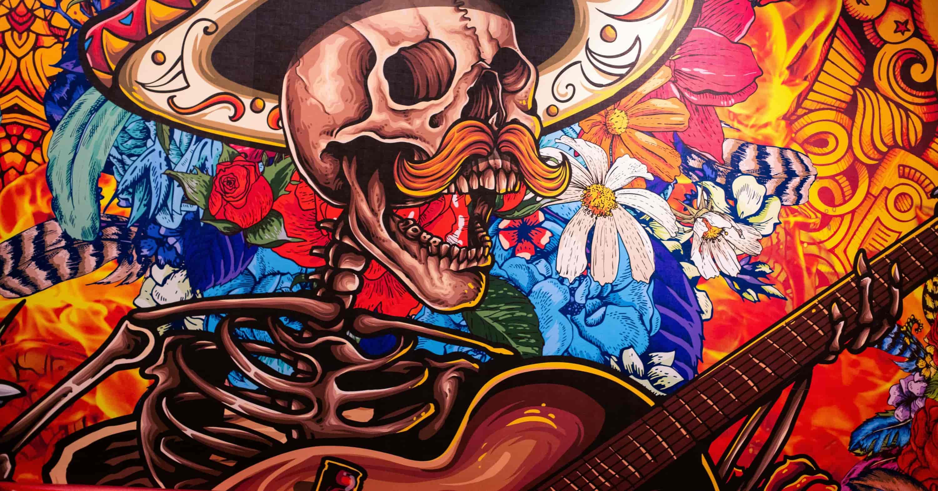 brown blue and yellow abstract painting showing a skeleton with a mustache playing the guitar and singing