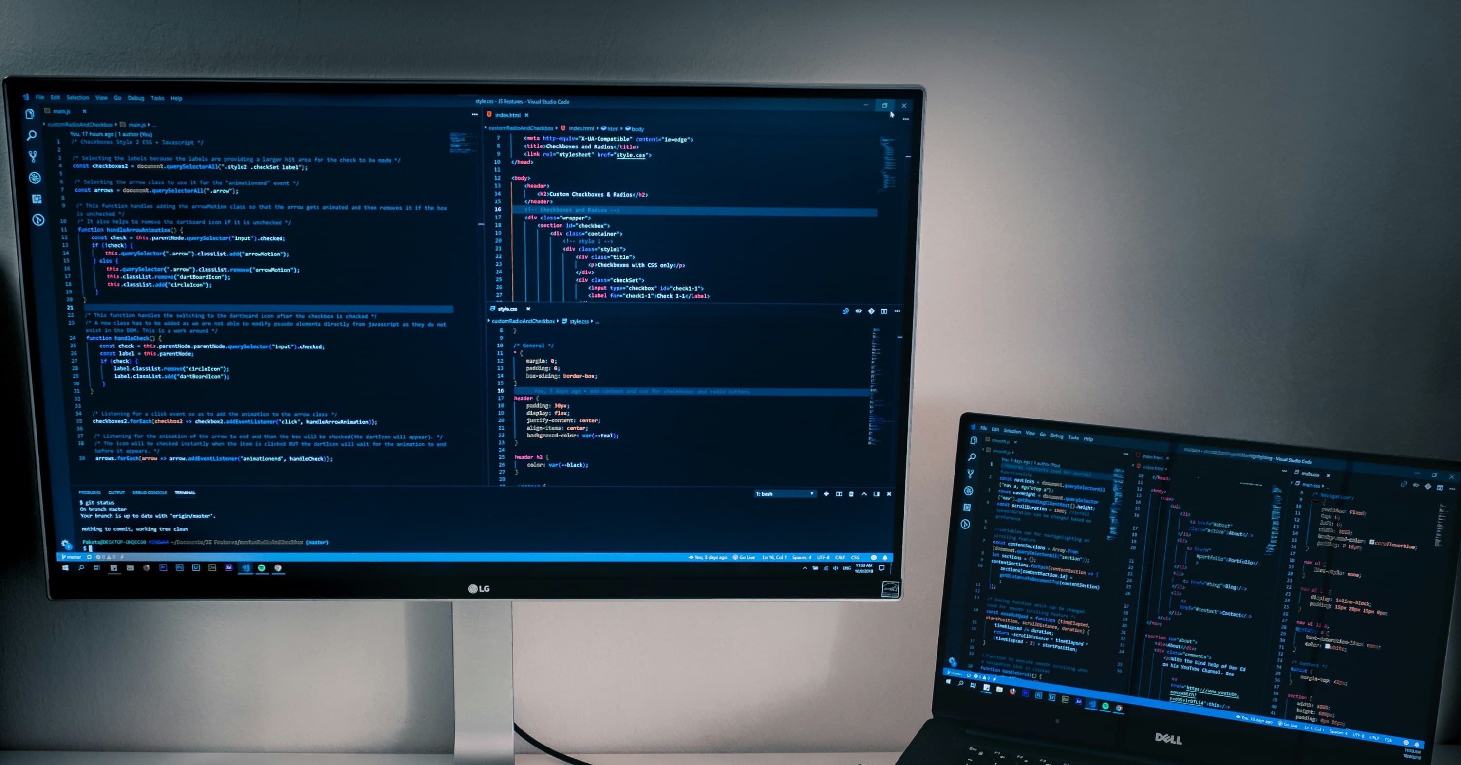laptop next to monitor with code on both screens